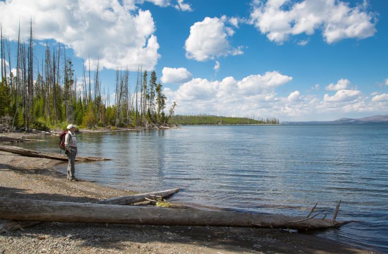hiker on shores of Yellowstone Lake