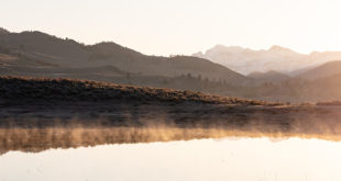 Steam from ephemeral ponds lit up at sunrise (panorama)